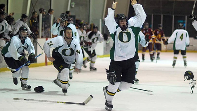 Players on the UO Club Sports hockey team celebrate on the ice