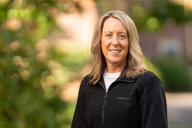 woman with long blond hair wearing a black fleece jacket