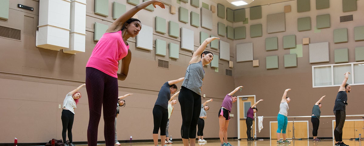 A group of students stretch after an UrbanKick Group X class