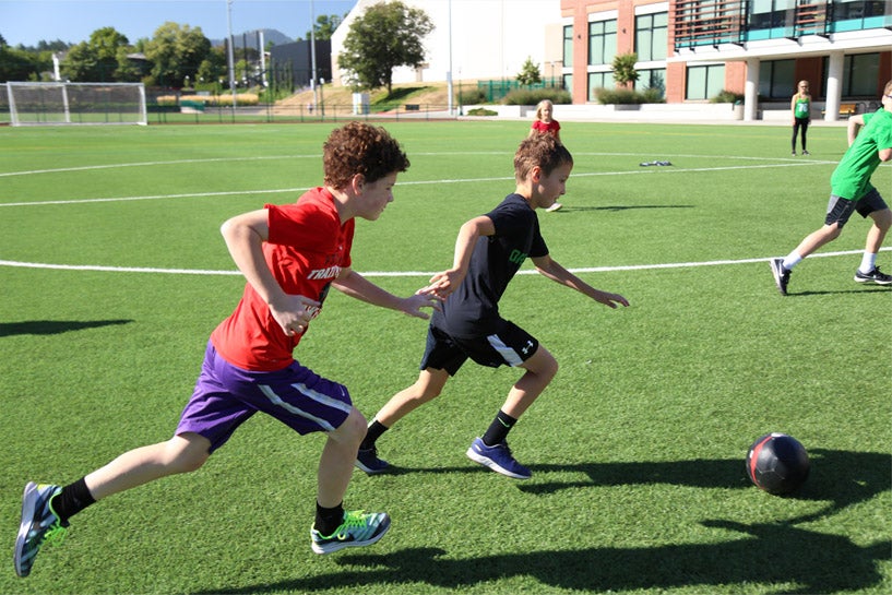 Kids play soccer on the Rec Center turf fields.